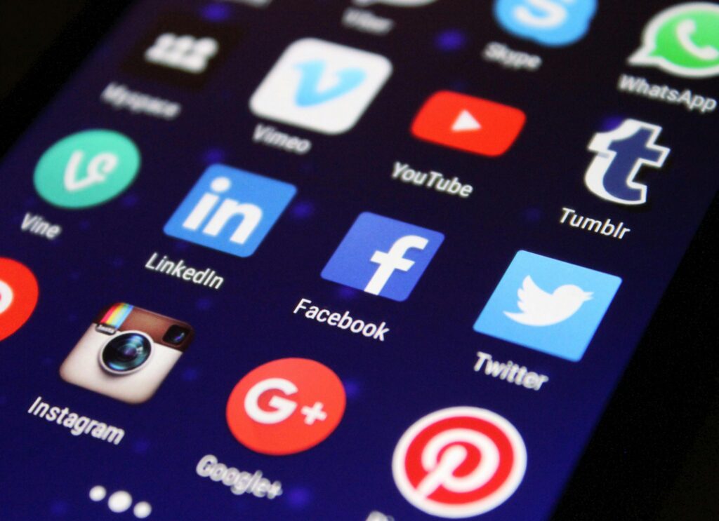 pexels-photo-267350-267350 Close-up of a smartphone screen showing various social media app icons such as Facebook and Twitter.